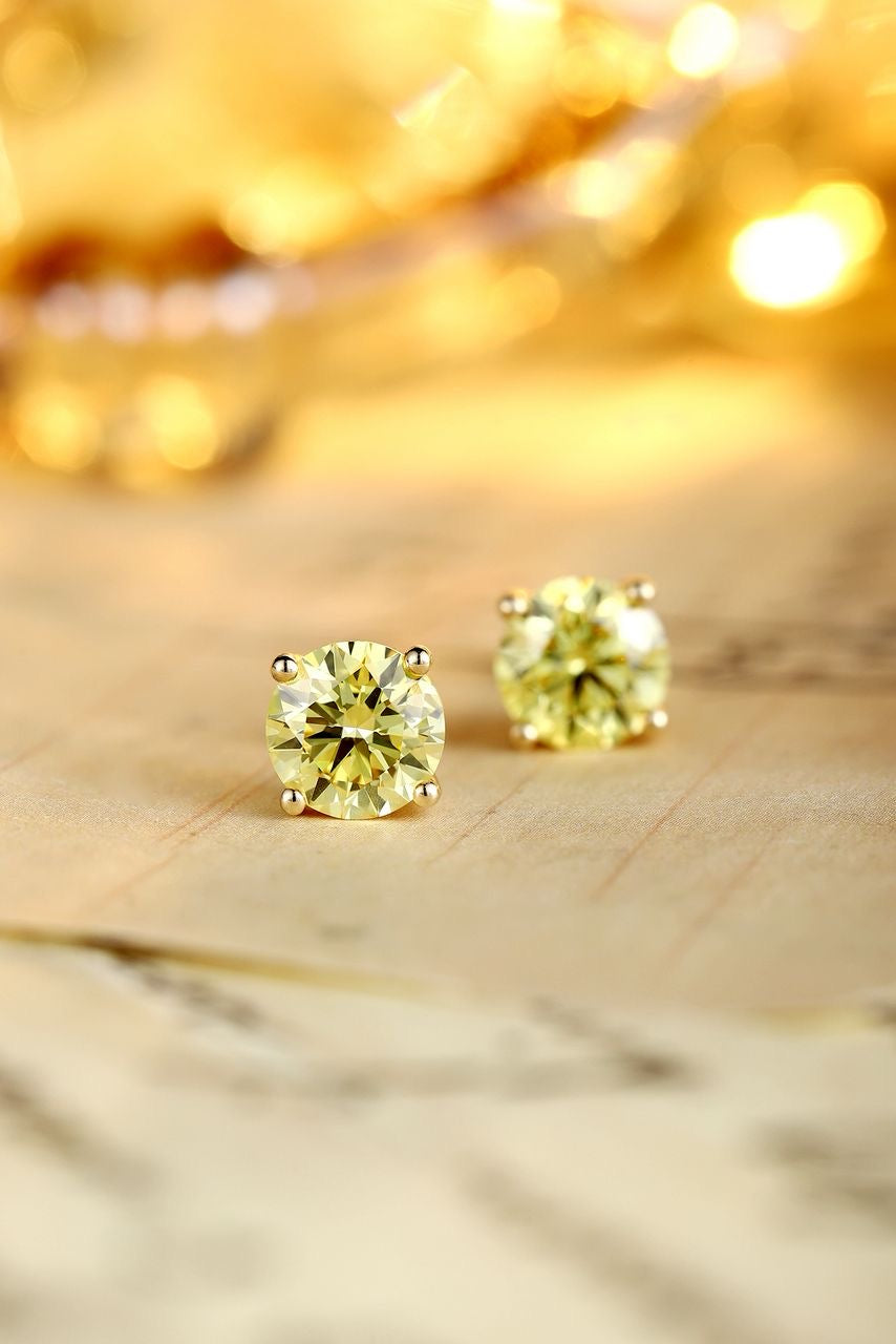 Diamond stud earrings by RIAZ